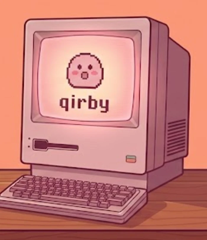xirby beside an old desktop computer with his face on the screen